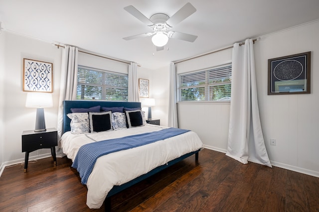 bedroom featuring ceiling fan, dark hardwood / wood-style floors, ornamental molding, and multiple windows