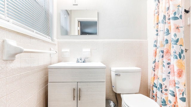 bathroom featuring tile walls, toilet, vanity, and decorative backsplash