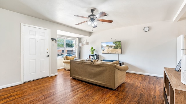 living room featuring ceiling fan and dark hardwood / wood-style floors