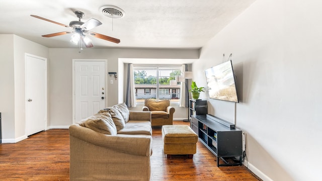 living room with ceiling fan and dark hardwood / wood-style floors