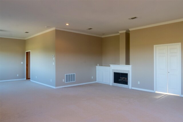 unfurnished living room featuring ornamental molding and carpet floors