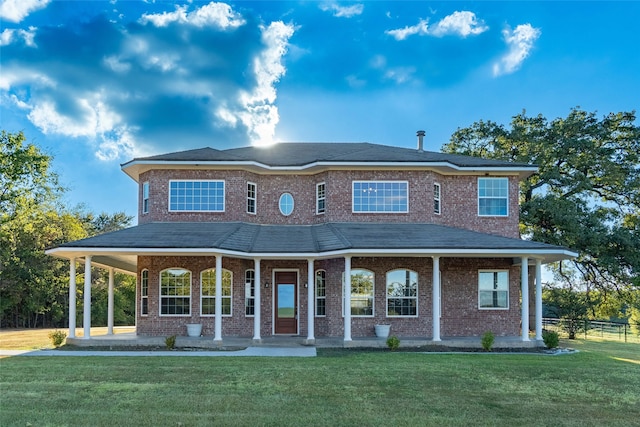 country-style home with a front yard and covered porch