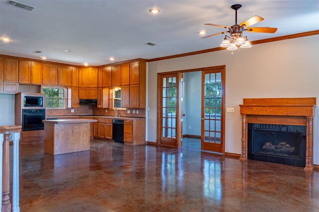 kitchen featuring plenty of natural light, black appliances, ceiling fan, and a center island