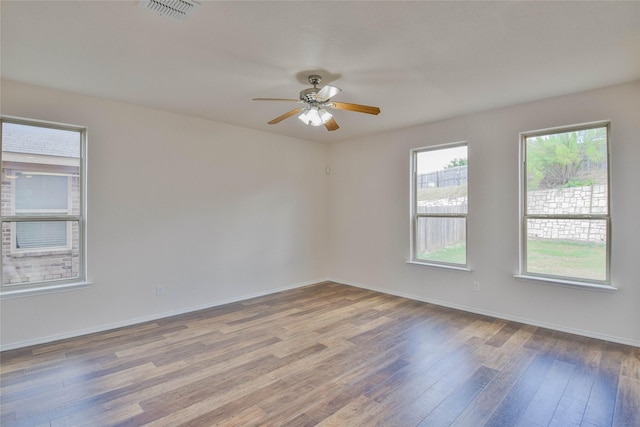 spare room with ceiling fan and wood-type flooring