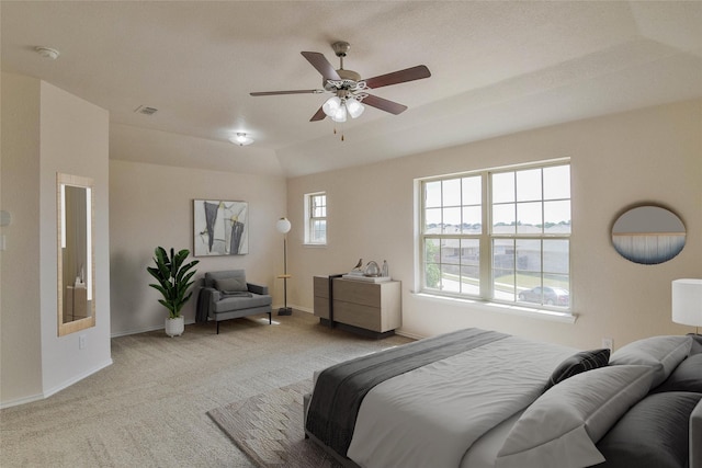 bedroom featuring light carpet, multiple windows, and ceiling fan