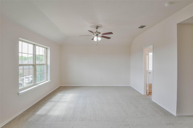 empty room featuring light carpet, ceiling fan, and lofted ceiling