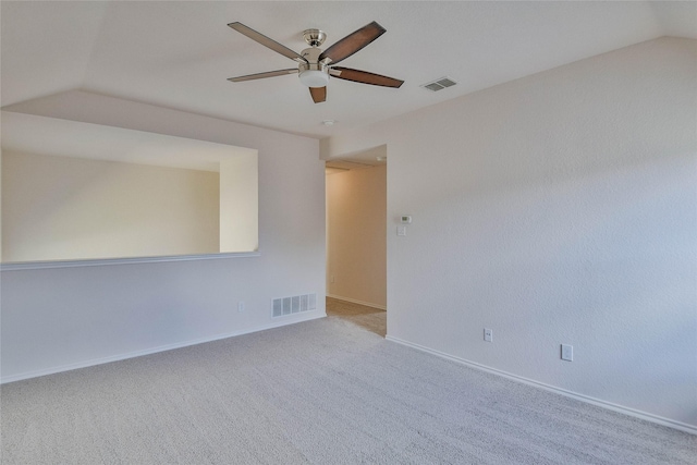 unfurnished room featuring ceiling fan, light colored carpet, and lofted ceiling