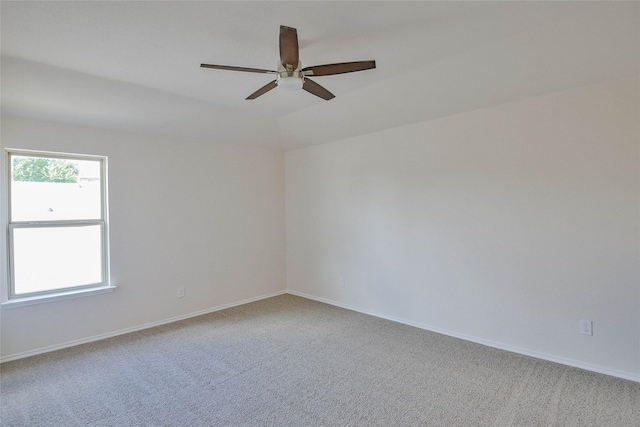 carpeted empty room with ceiling fan and lofted ceiling