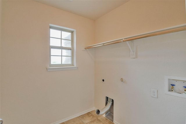 washroom featuring hookup for an electric dryer, light tile patterned floors, and hookup for a washing machine