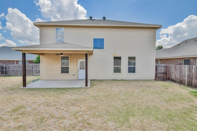 back of property featuring a yard, a patio, and ceiling fan