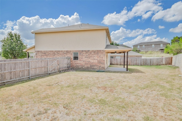 back of house featuring a yard