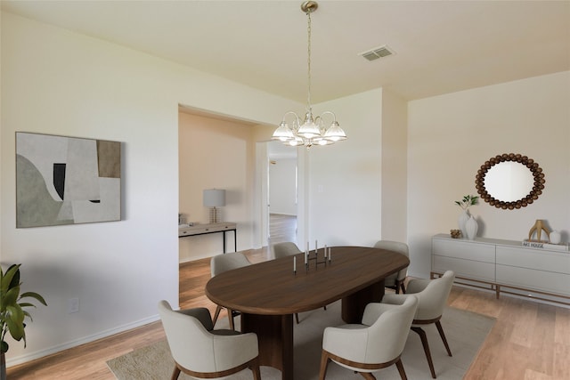 dining room featuring an inviting chandelier and light hardwood / wood-style flooring