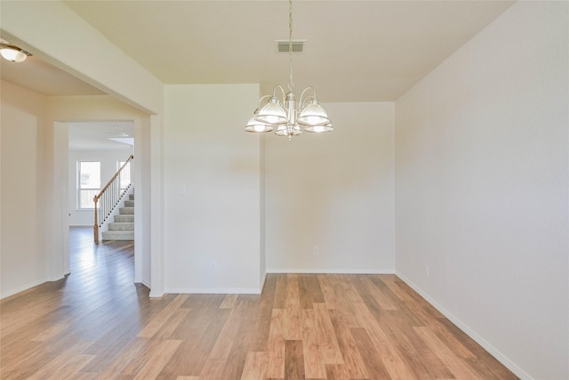 interior space featuring a notable chandelier and light wood-type flooring