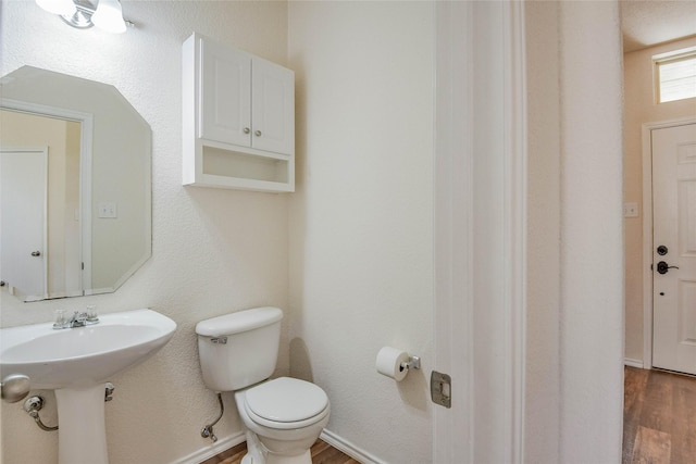 bathroom with sink, toilet, and hardwood / wood-style flooring