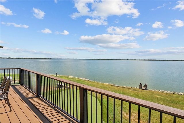 wooden deck featuring a water view and a lawn