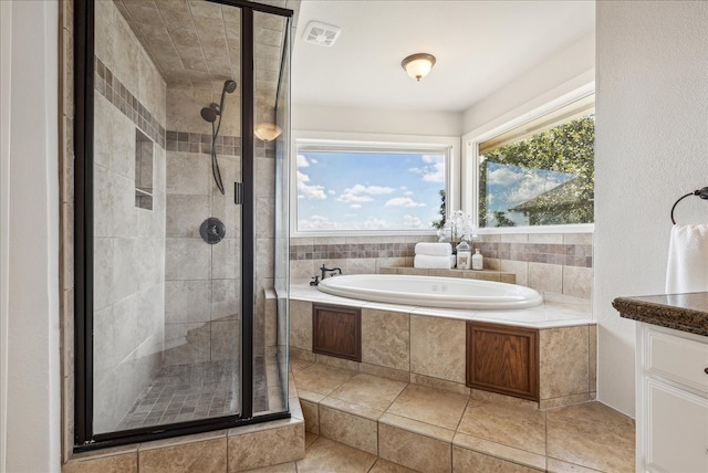 bathroom featuring tile patterned flooring, vanity, and independent shower and bath