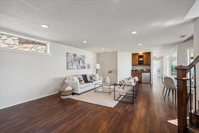 living room featuring a healthy amount of sunlight and dark hardwood / wood-style floors