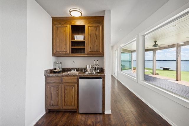 bar with dark wood-type flooring, ceiling fan, stainless steel dishwasher, and sink