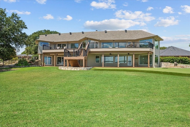 back of property with a lawn and a deck