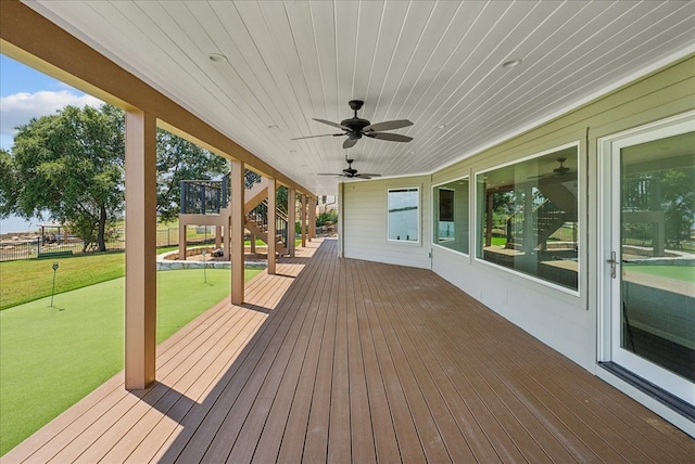 wooden deck with a lawn and ceiling fan