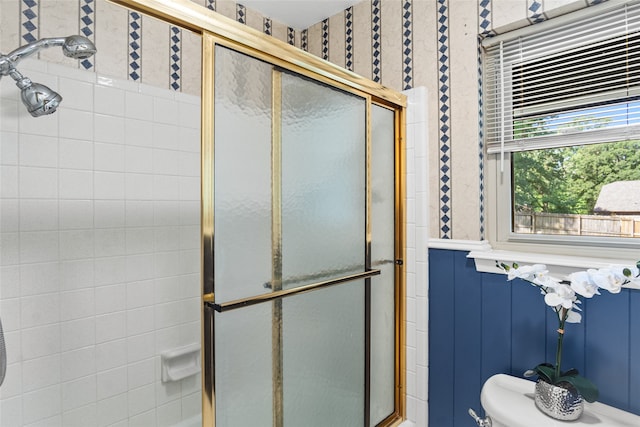 bathroom featuring a shower with door