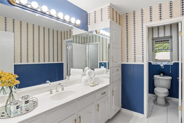 bathroom featuring tile patterned flooring, vanity, and toilet