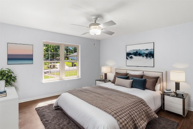 bedroom featuring ceiling fan, baseboards, and wood finished floors