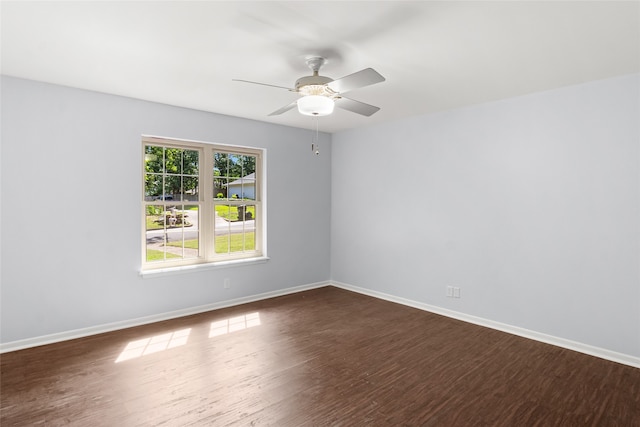 spare room featuring dark wood-type flooring and ceiling fan