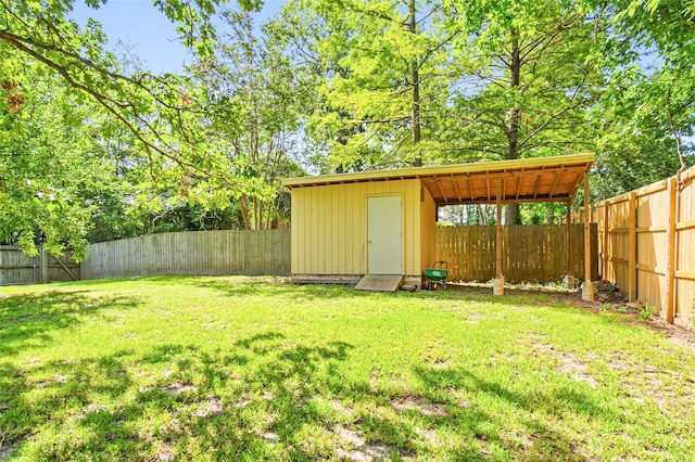 view of yard with a storage unit, an outbuilding, and a fenced backyard