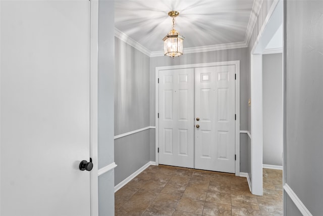 foyer entrance featuring crown molding and a chandelier