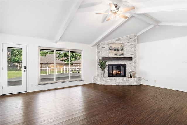 unfurnished living room with lofted ceiling with beams, wood finished floors, a fireplace, baseboards, and ceiling fan