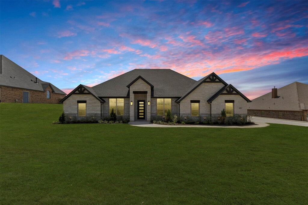 french country home featuring a front lawn