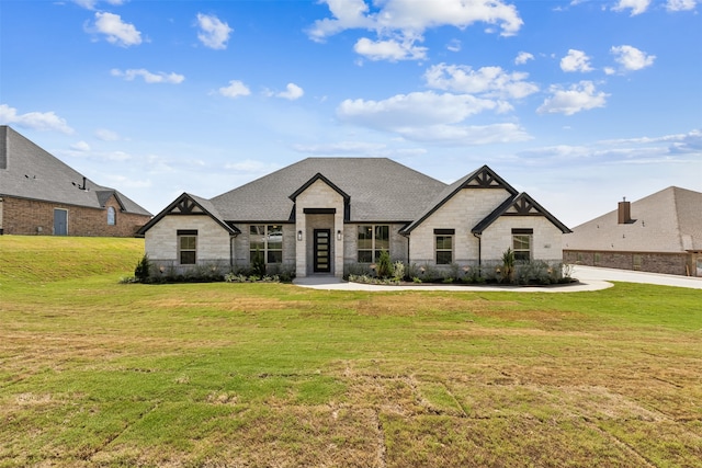 french country home featuring a front lawn