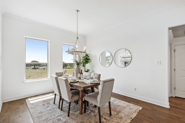 dining space featuring crown molding, a notable chandelier, and dark hardwood / wood-style floors