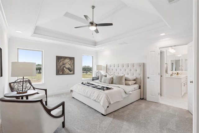 bedroom featuring a raised ceiling, light carpet, and multiple windows