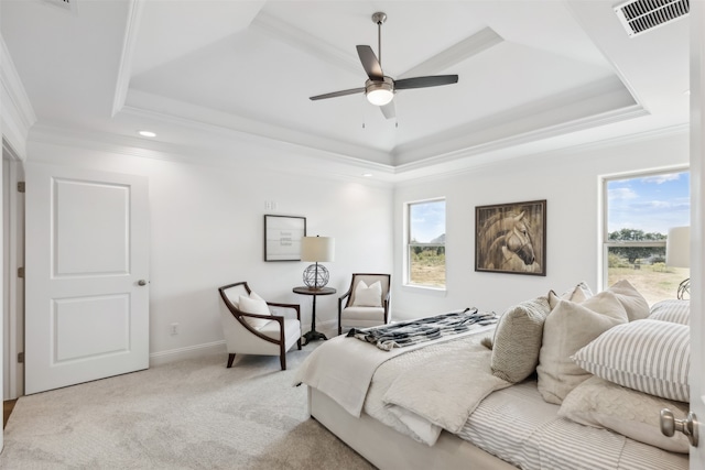 carpeted bedroom featuring ceiling fan, a raised ceiling, and crown molding