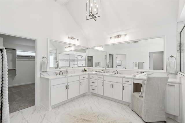 bathroom with vanity, a notable chandelier, and high vaulted ceiling