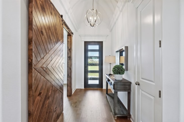 doorway to outside featuring a barn door, an inviting chandelier, and dark wood-type flooring