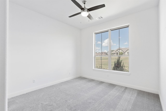 spare room with ceiling fan and light colored carpet