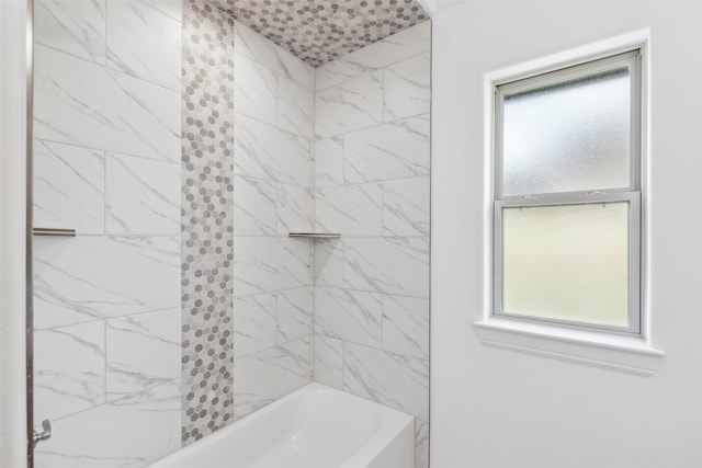 bathroom featuring tiled shower / bath combo and plenty of natural light