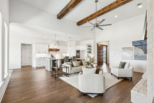 living room featuring ceiling fan, plenty of natural light, dark hardwood / wood-style flooring, and beam ceiling