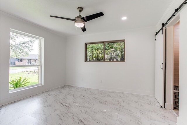 empty room with plenty of natural light, light marble finish floors, and a ceiling fan