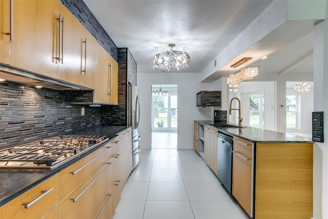 kitchen featuring a sink, a chandelier, black dishwasher, dark countertops, and recessed lighting