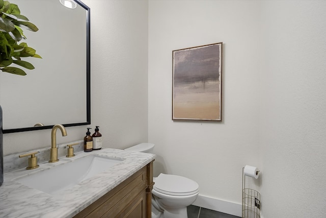 bathroom with vanity, toilet, and tile patterned flooring