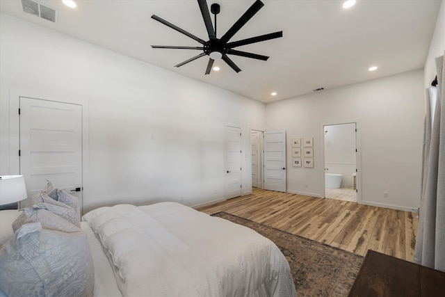 bedroom featuring light hardwood / wood-style flooring, ensuite bathroom, and ceiling fan