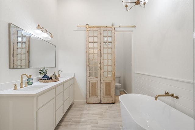 bathroom featuring vanity, a bathtub, and toilet