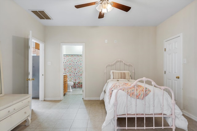 tiled bedroom featuring ensuite bathroom and ceiling fan