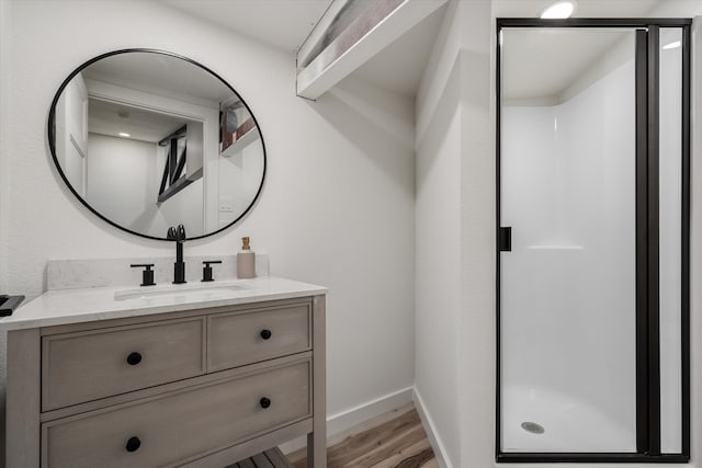 bathroom with vanity, hardwood / wood-style flooring, and an enclosed shower