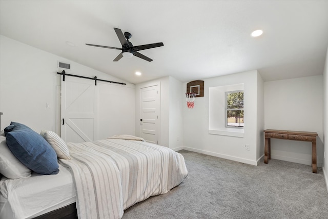 bedroom with lofted ceiling, carpet, a barn door, and ceiling fan