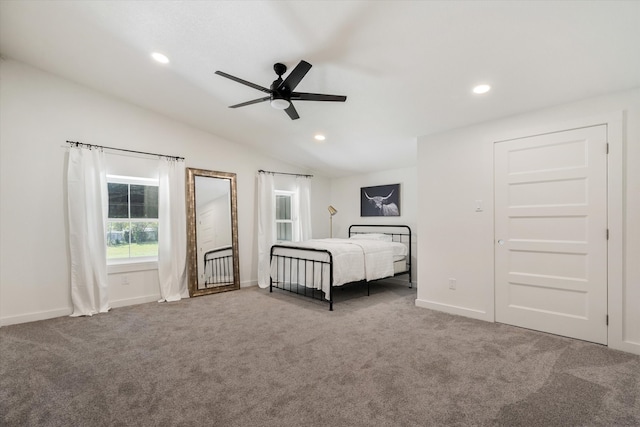 unfurnished bedroom with carpet, vaulted ceiling, and ceiling fan